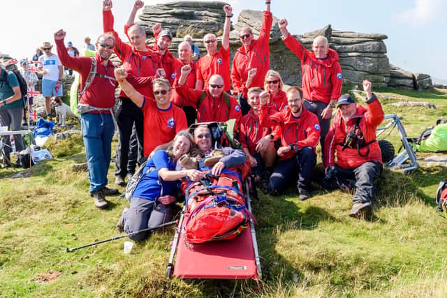 The North Dartmoor Search and Rescue Team celebrate with Gilbert and Jane at the top of the Tor – Photographs © Chris Saville