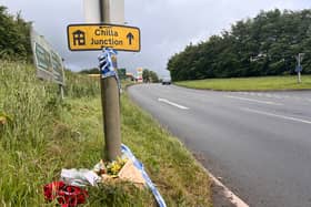 Floral tributes left at the Chilla Junction sign near the crash site