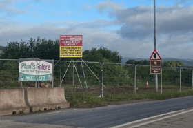 Signs erected by Tony Joyner amid an ongoing saga related to a compulsory purchase order of part of his land