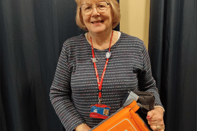 Barbara Dalton with a defibrilator device