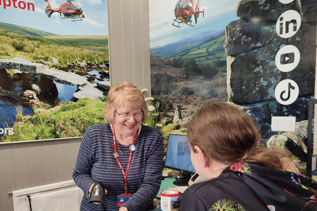 Barbara Dalton serving a customer in the Okehampton shop