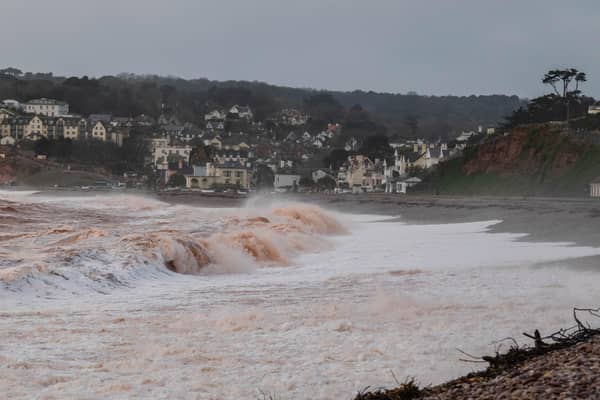 Storm waves crashing onto the pebbled beach at Budleigh Salterton in Devon
