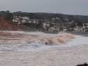 Storm waves crashing onto the pebbled beach at Budleigh Salterton in Devon