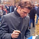 Ákos Buzsáky signing a QPR fan's shirt outside Loftus Road