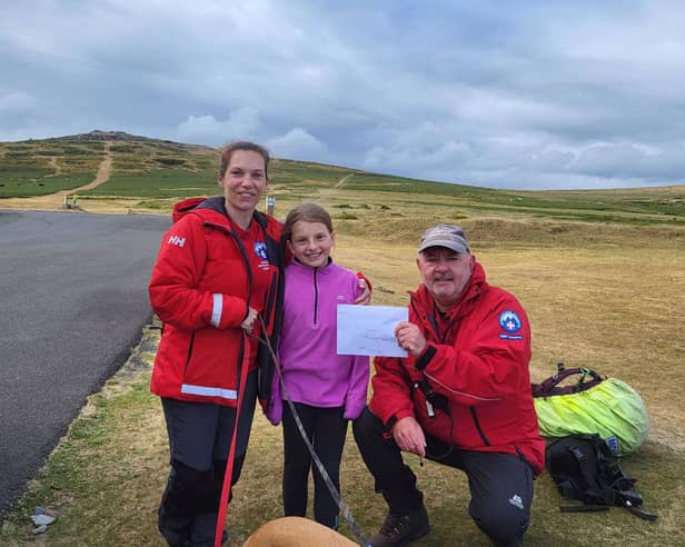 Olivia Ball (centre) with mum Becks (left) and DSRT John (right)