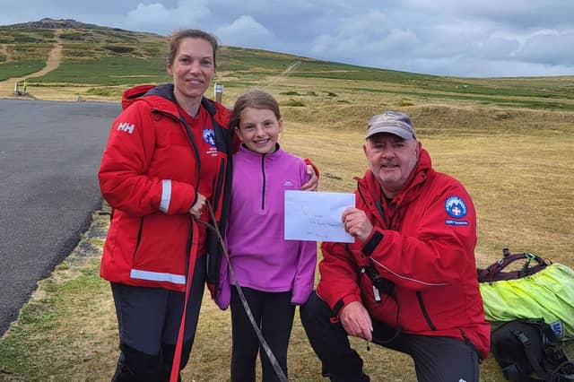 Olivia Ball (centre) with mum Becks (left) and DSRT John (right)
