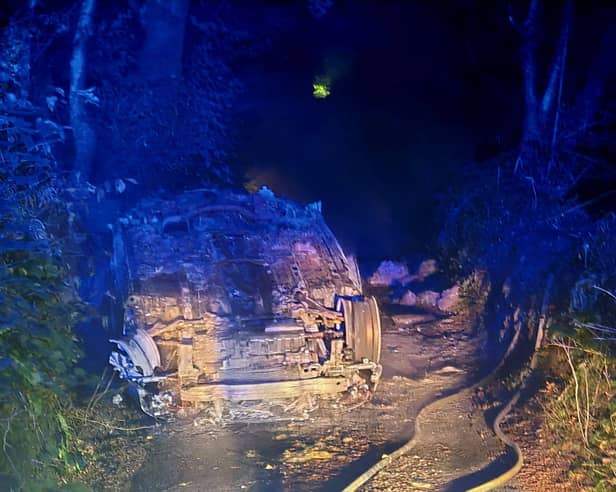 The overturned car in the lane near South Brent