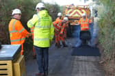 Cllr Dan Thomas with a Rapid Reaction Team repairing a road  
