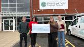 Westbank&rsquo;s Katie Elliott (in red T-shirt) being presented with a cheque by students at Exeter Medical School
