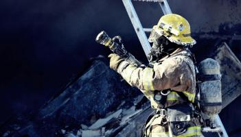 Firefighter Holding Water Hose Credit- Tim Eiden