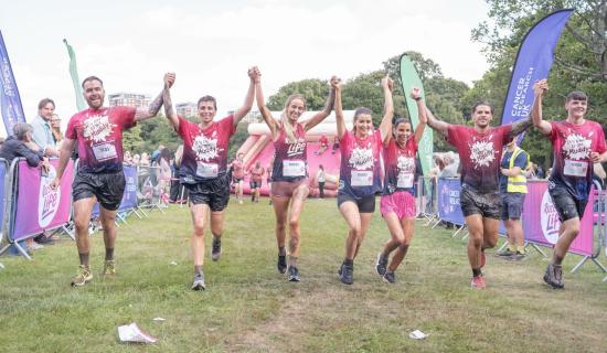 Leanne Quigley crosses the finish line with partner Sophie Jones & friends (Image- Cancer Research)