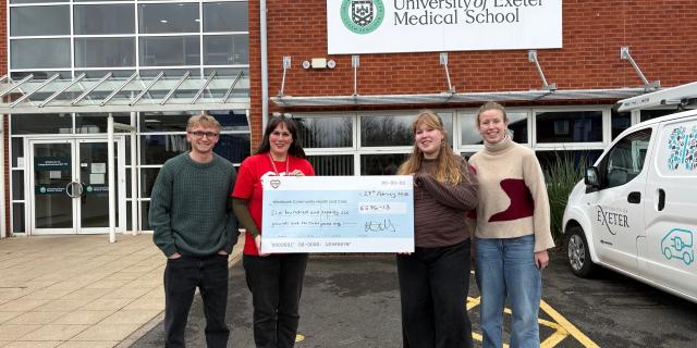 Westbank&rsquo;s Katie Elliott (in red T-shirt) being presented with a cheque by students at Exeter Medical School