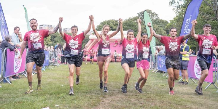 Leanne Quigley crosses the finish line with partner Sophie Jones & friends (Image- Cancer Research)