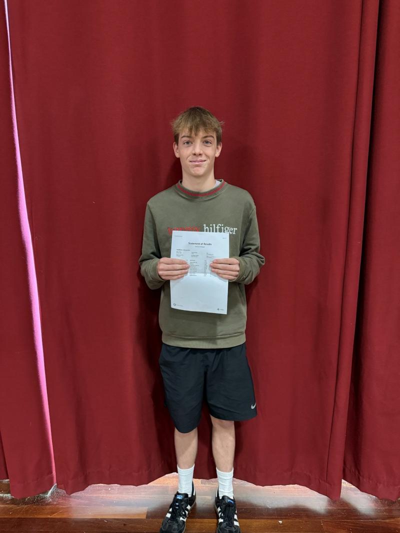 Tavistock College Student Will Metters holds up his GCSE results