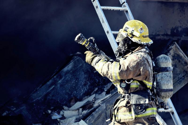 Firefighter Holding Water Hose Credit- Tim Eiden