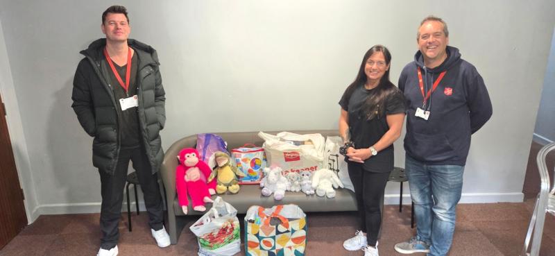 Salvation Army Community Mission Manager Andy Bichard, left,  Major Matt Elsey, far right,  and Wendy from Winners 2000