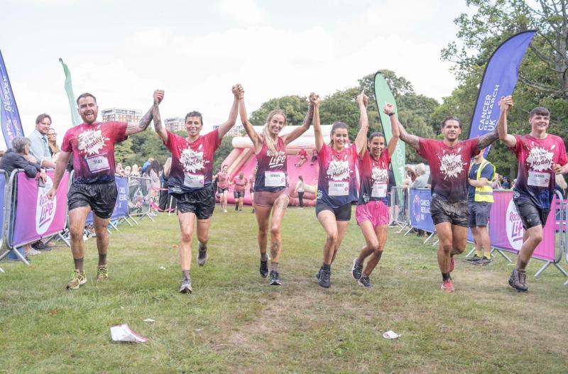 Leanne Quigley crosses the finish line with partner Sophie Jones & friends (Image- Cancer Research)
