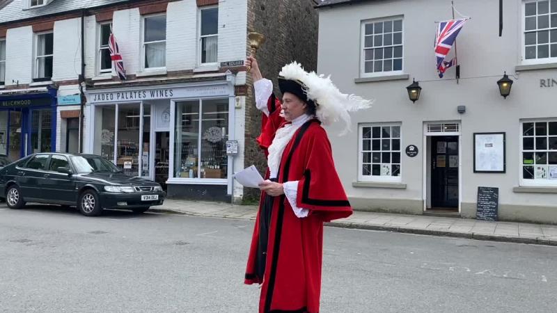 Visitors to local town surprised by a man in scarlet tights and feathers in his cap