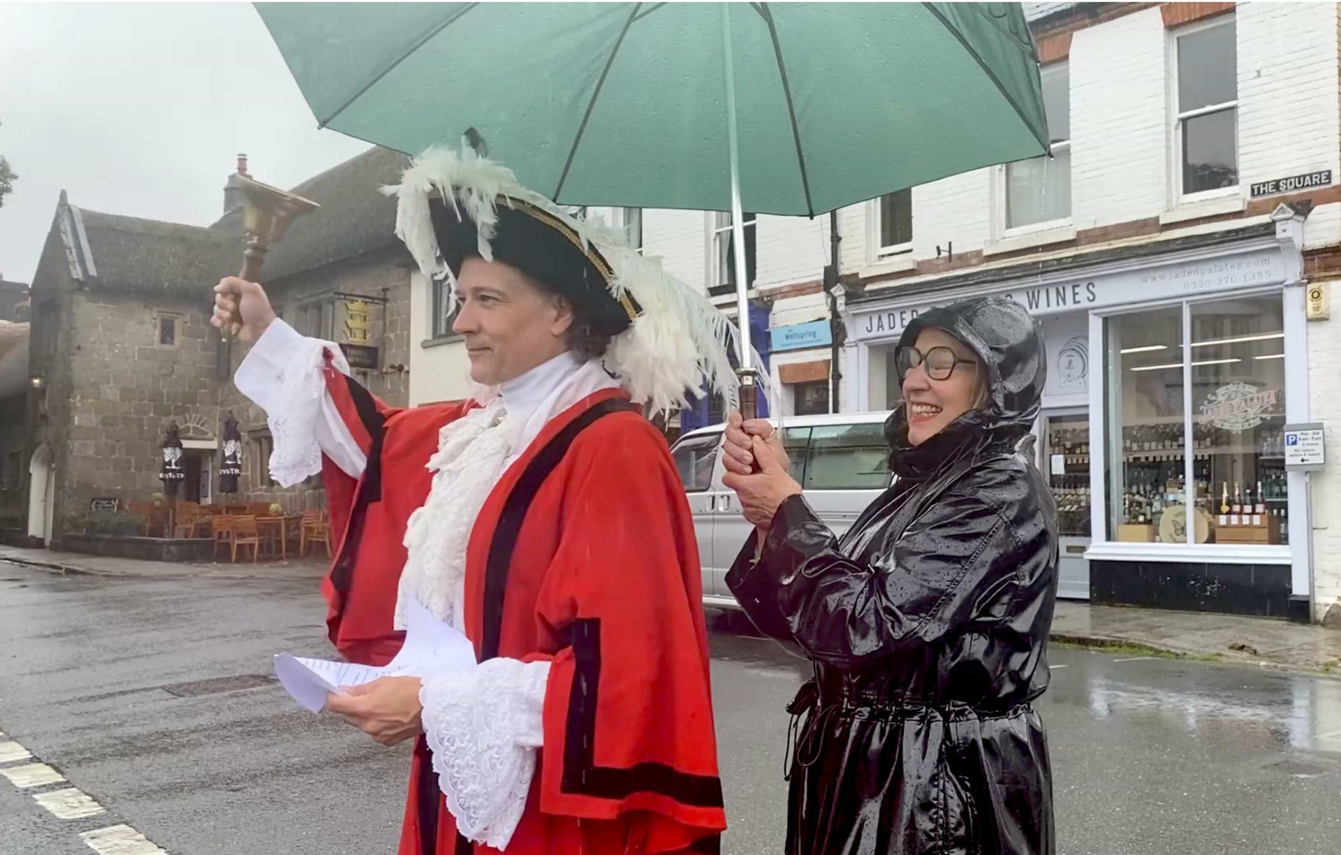 Tom Fynn, Chagford actor and town crier with Sue McNeil (official umbrellera-holder!)